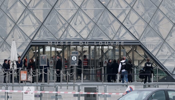Forensic police officers arrive at the Louvre museum after reports of a robbery, in Paris, France, October 19, 2025. — Reuters