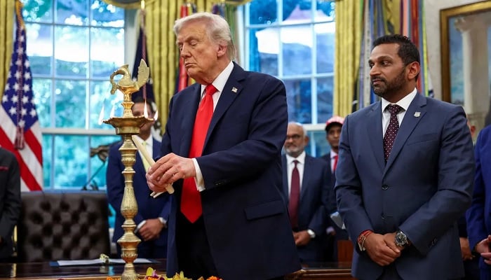 FBI Director Kash Patel looks on as U.S. President Donald Trump lights a candle as he participates in a Diwali celebration in the Oval Office of the White House in Washington, DC, US, October 21, 2025. —Reuters