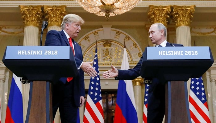 President Donald Trump and Russias President Vladimir Putin shake hands during a joint news conference after their meeting in Helsinki, Finland, July 16, 2018. — Reuters