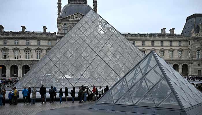 Visitors queue to enter the Louvre museum in Paris. — AFP