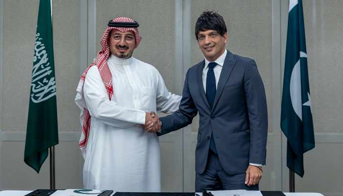 PFF President Mohsin Gilani (right) and SAFF President Yasser Al-Misehal shaking hands after signing agreement. — Reporter