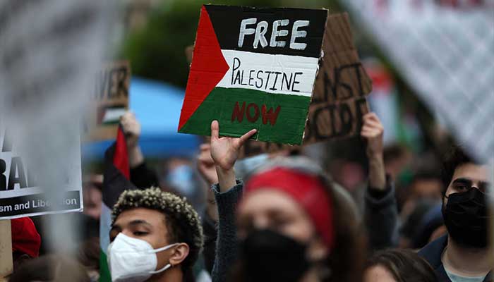 A protester holds a sign as students and others demonstrate at a protest encampment at University Yard in support of Palestinians in Gaza at George Washington University in Washington, April 25, 2024. — Reuters