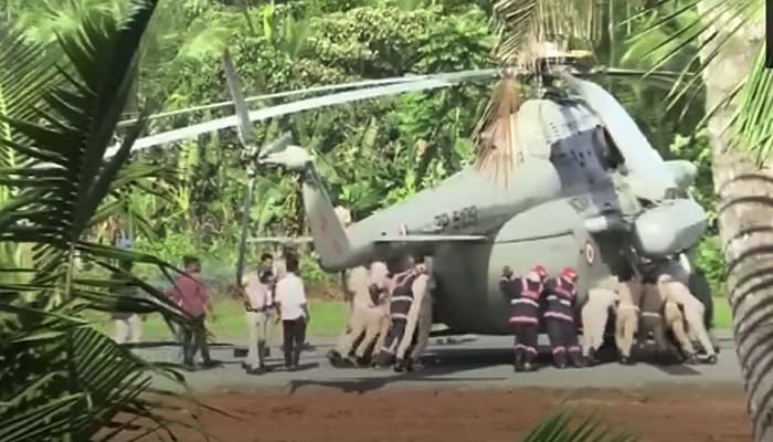 Indian officials pushing Indian Air Forces Mi-17 chopper at Rajiv Gandhi Indoor Stadium on October 22, 2025. — YouTube/@indiatimes/screengrab