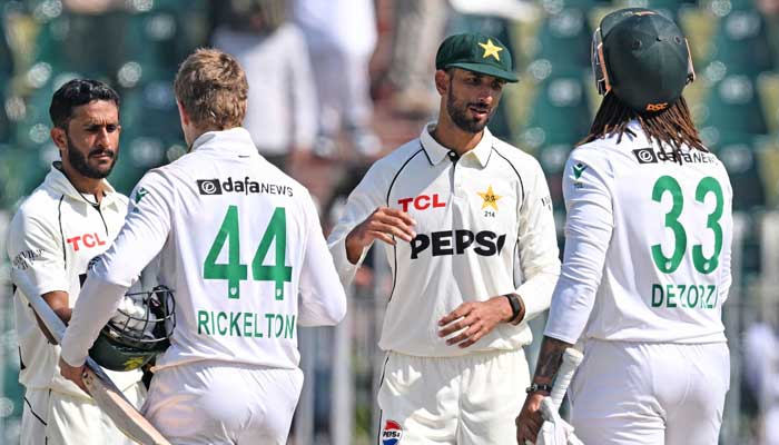 Pakistans Shan Masood (second right) shakes hands with South Africas  Tony de Zorzi at the end of the second Test cricket match between Pakistan and South Africa at the Rawalpindi Cricket Stadium, in Rawalpindi on October 23, 2025. — AFP