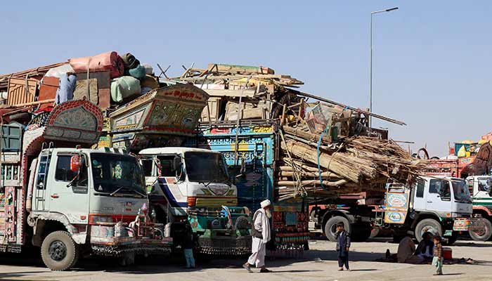 A man walks near children next to parked vehicles loaded with the belongings of Afghan citizens attempting to return to their country, after Pakistan closed border crossings with Afghanistan following exchanges of fire between the nations forces, at the border crossing in Chaman, Balochistan, October 16, 2025. — Reuters