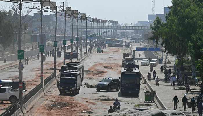 Police personnel patrol a street following crackdown on Tehreek-e-Labbaik Pakistan (TLP) party activists during an anti-Israel protest in Muridke on October 13, 2025. — AFP