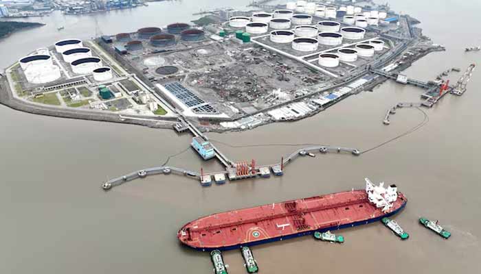 An aerial view shows tugboats helping a crude oil tanker to berth at an oil terminal, off Waidiao Island in Zhoushan, Zhejiang province, China, July 18, 2022. — Reuters