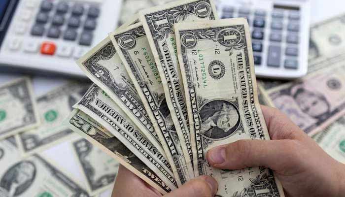 A person counts dollar notes in this illustrative image taken on May 30, 2022. — Reuters