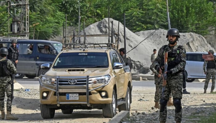 Security personnel stand guard in Bajaur district of Khyber Pakhtunkhwa. — AFP/File