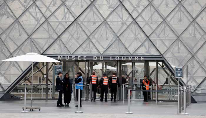 Security employees enter the glass Pyramid of the Louvre Museum as the museum remains closed the day after a spectacular jewel heist by thieves,in Paris, France, October 20, 2025.— Reuters