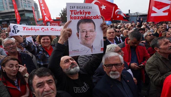 A supporter of the main opposition Republican Peoples Party (CHP) holds a poster featuring a picture of jailed Istanbul Mayor Ekrem Imamoglu during a protest near the Justice Palace on October 26, 2025. — Reuters