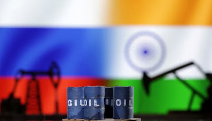 A model of an oil pump jack and oil barrels are seen in front of Russian and Indian flags in this illustration taken, December 9, 2022. — Reuters