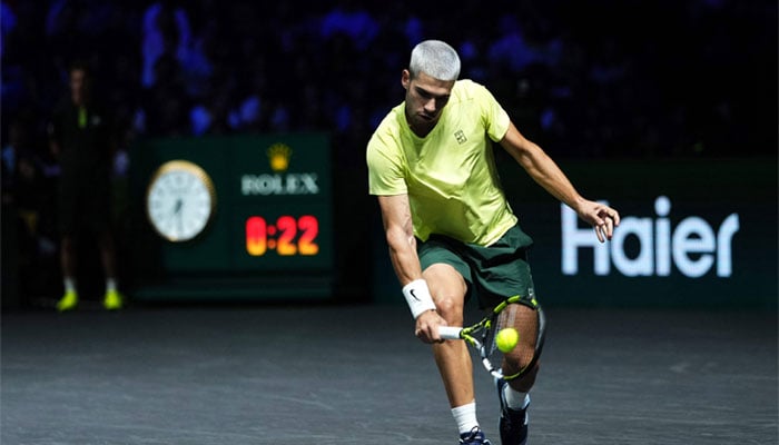Spains Carlos Alcaraz plays a backhand return to Britains Cameron Norrie during their mens singles match on day two of the Paris ATP Masters 1000 tennis tournament at the Paris La Défense Arena in Nanterre, on the outskirts of Paris, on October 28, 2025. — AFP