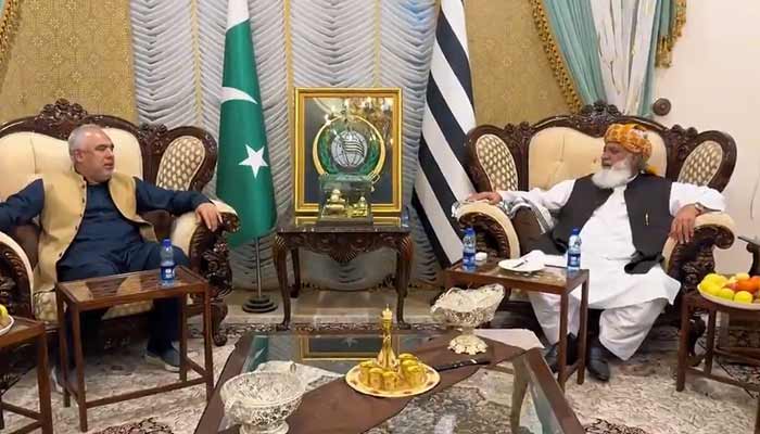 Jamiat Ulema-e-Islam-Fazl chief Maulana Fazlur Rehman (right) meets Pakistan Tehreek-e-Insaf leader Asad Qaiser (left) at formers residence in Islamabad, October 29, 2025. — Screengrab via X/@juipakofficial