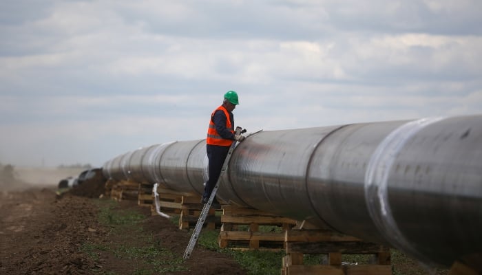 Representational image shows a worker next to a pipe at a construction site. — Reuters