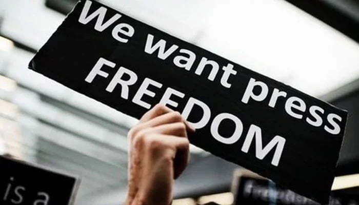 Representational image shows a person holding a placard. — AFP/File