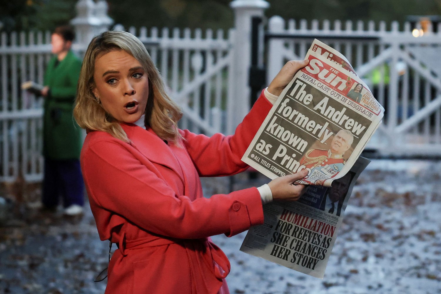 A member of the media shows the front page of a newspaper outside the entrance to the Royal Lodge. REUTERS/Suzanne Plunkett