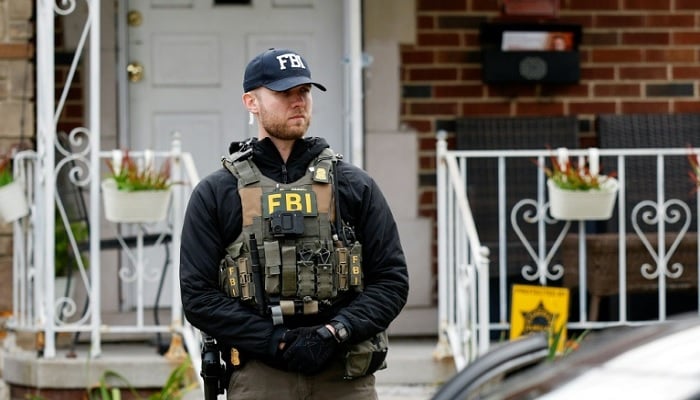 An FBI agent stands outside a home in Dearborn on October 31, 2025, Michigan, after FBI Director Kash Patel said the agency had thwarted a potential terrorist attack. — AFP