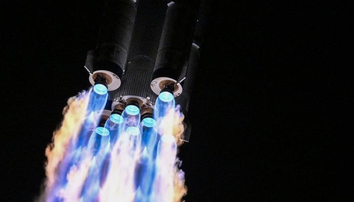 A Long March-2F carrier rocket, carrying the Shenzhou-21 spacecraft and a crew of three astronauts, lifts off from the Jiuquan Satellite Launch Centre in the Gobi desert, in northwest China on October 31, 2025.  AFP