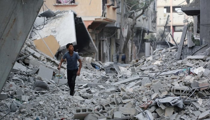 Palestinian youth looks at destroyed buildings in Jabalia in the northern Gaza Strip on October 12, 2025. — AFP