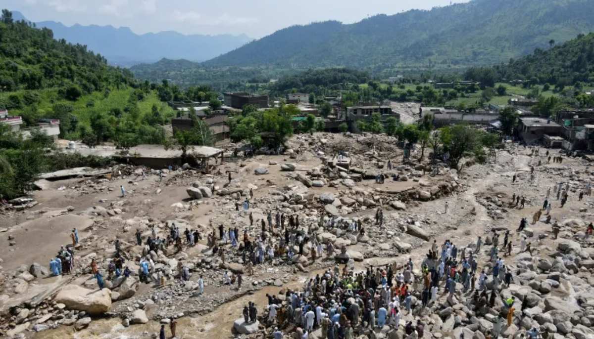 Flood survivors gather near damaged houses along the banks of a river in the Buner district of Khyber Pakhtunkhwa on August 17, 2025. — AFP