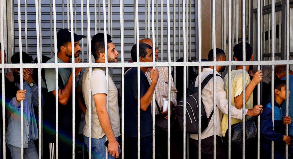 People queue outside the Bank of Palestine amid a cash shortage, in Nuseirat, central Gaza Strip, October 27, 2025. — Reuters