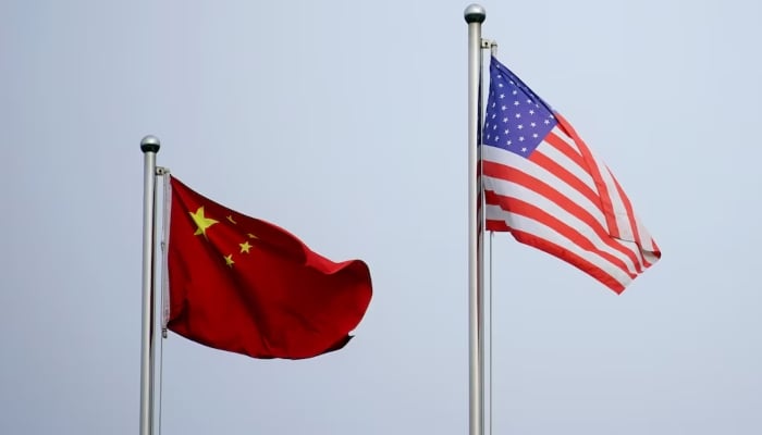 Chinese and US flags flutter outside a company building in Shanghai, China April 14, 2021. — Reuters