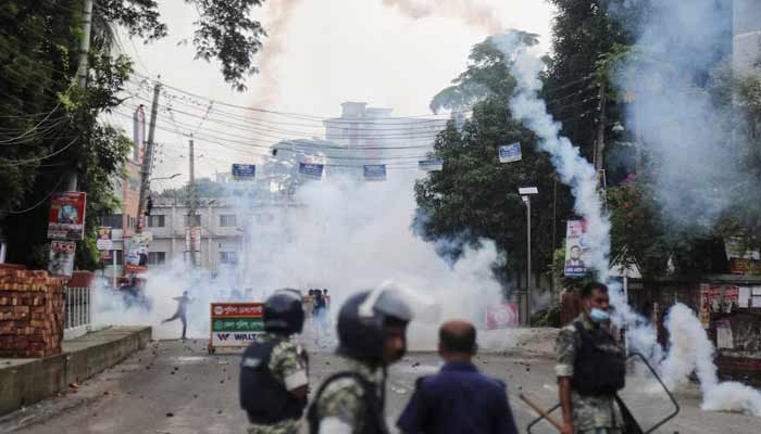 Security forces throw tear gas cans and sound grenades to disperse the protesters in Gopalganj, Bangladesh. — Reuters