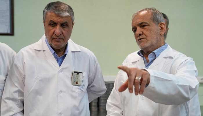 Iranian President Masoud Pezeshkian speaks with Mohammad Eslami, Head of the Iranian Atomic Energy Organisation, in Tehran, Iran, November 2, 2025.— Reuters