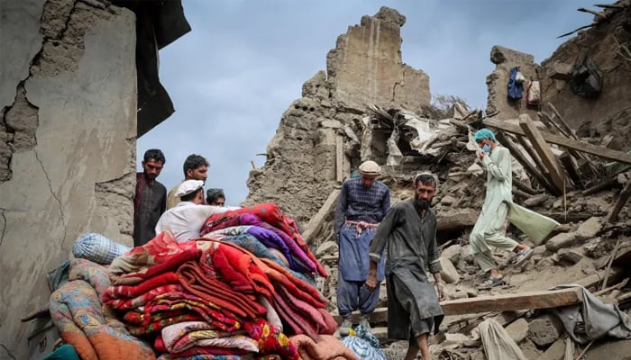 Afghan men walk on the rubble of a damaged house following a deadly magnitude-6 earthquake that struck Afghanistan on Sunday, in Mazar Dara, Kunar province, Afghanistan, September 2, 2025. — Reuters