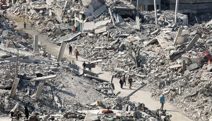 Palestinians walk past the rubble of destroyed buildings, amid a ceasefire between Israel and Hamas, in Gaza City, November 2, 2025. — Reuters