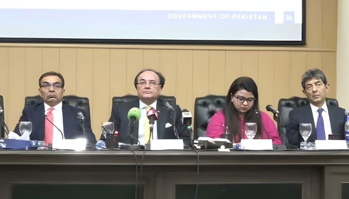 Finance Minister Muhammad Aurangzeb (second left) addresses a presser in Islamabad on November 3, 2025. — Screengrab Geo News