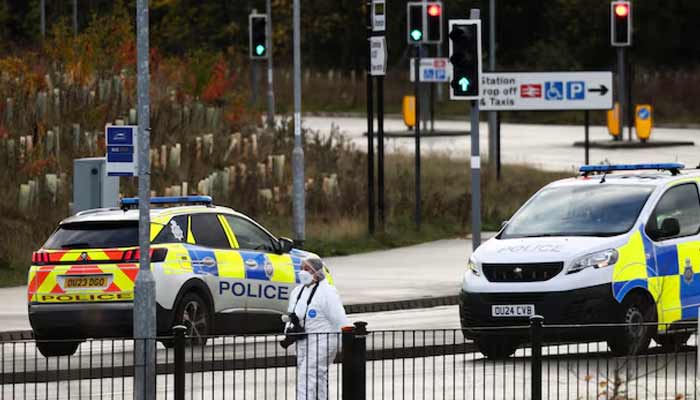 A forensic officer walks near the scene at Huntingdon Station following a series of stabbings on a train, near Cambridge, Britain, November 2, 2025.— Reuters