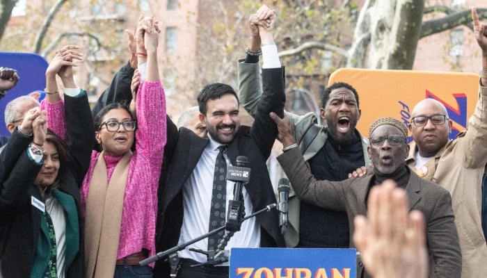 Democratic New York City mayoral candidate Zohran Mamdani (centre) raises his hands during a campaign event with New York City elected officials in New York City, November 1, 2025. — AFP