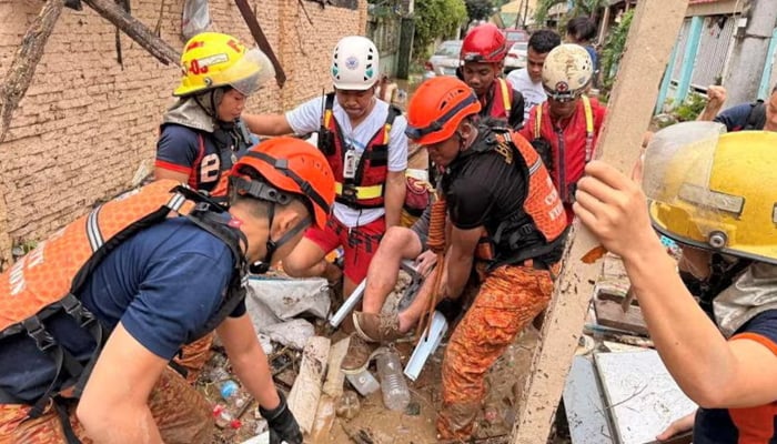 Philippine Red Cross personnel rescue a resident following torrential rains brought by Typhoon Kalmaegi, in Talamban, Cebu City, Philippines, November 4, 2025. — Reuters