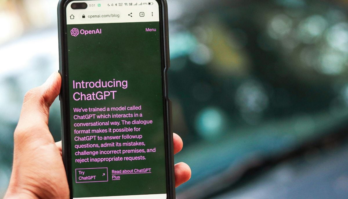 A representational image shows a person using ChatGPT on their smartphone. — Canva