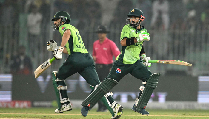 Pakistans Mohammad Rizwan (R) and Salman Agha (L) run between the wickets during the first ODI match between Pakistan and South Africa at the Iqbal Stadium in Faisalabad on November 4, 2025. — AFP