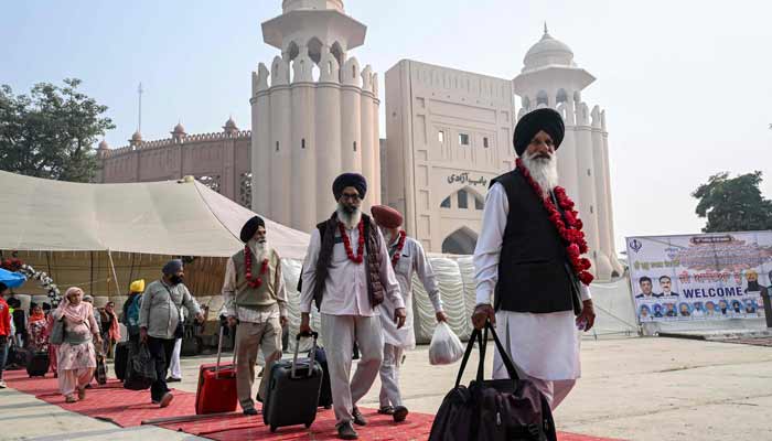 Indian Sikh pilgrims arrive in Pakistan after crossing the India-Pakistan Wagah border in Wagah on November 4, 2025, on the eve of celebrations marking the birth anniversary of Guru Nanak, founder of Sikhism. — AFP