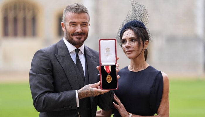 Sir David Beckham, stands with his wife Lady Victoria, after he was made a Knight Bachelor at an investiture ceremony at Windsor Castle, Berkshire. November 4, 2025. Andrew Matthews/Pool via REUTERS TPX IMAGES OF THE DAY