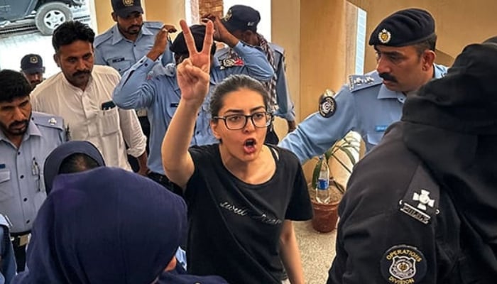 Police officials present arrested lawyer and human rights activist Imaan Mazari-Hazir (centre) before a court in Islamabad on August 20, 2023. — AFP
