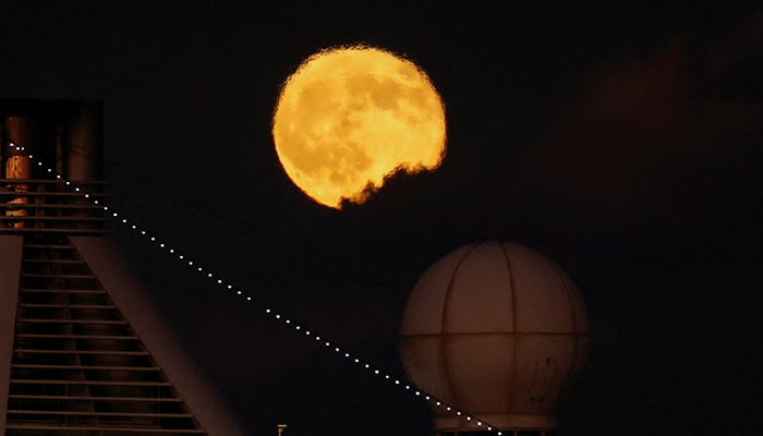 The first supermoon of the year, known as the Harvest Moon, rises over the passenger ship Marina as it departs from Grand Harbour in Valletta, Malta, October 7, 2025. — Reuters