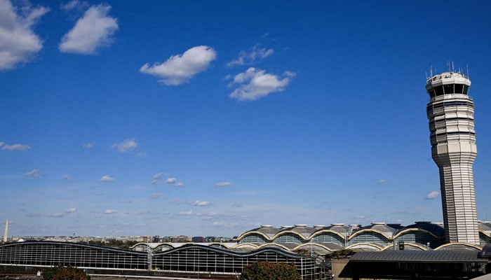 The control tower at Ronald Reagan Washington National Airport, with the Washington Monument in the background, is seen as the US government shutdown continues on November 6, 2025. — Reuters