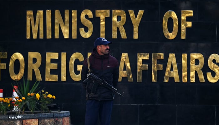 A police officer stands guard outside the Ministry of Foreign Affairs in Islamabad on January 18, 2024. — AFP