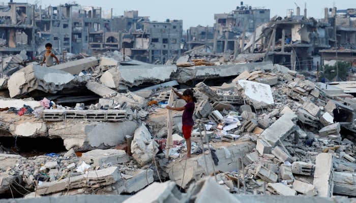 Palestinian children stand on the rubble of destroyed buildings in Jabalia, northern Gaza Strip, November 6, 2025. — Reuters