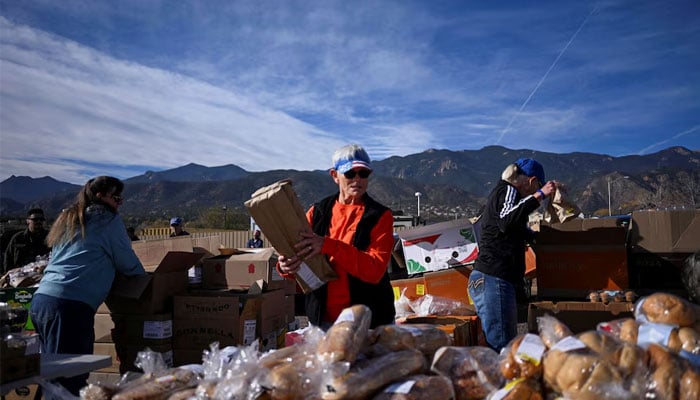 Volunteers prepare food for more than 100 cars in line at the Mt. Carmel Veterans Service Center food distribution site, weeks into the continuing US government shutdown, in Colorado Springs, Colorado, US, November 7, 2025. — Reuters