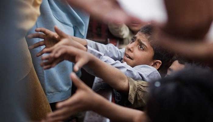 A child lines up in a queue for food. — Reuters/File