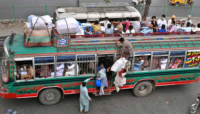 Commuters travel in an overcrowded bus in Lahore, on May 7, 2021. — AFP