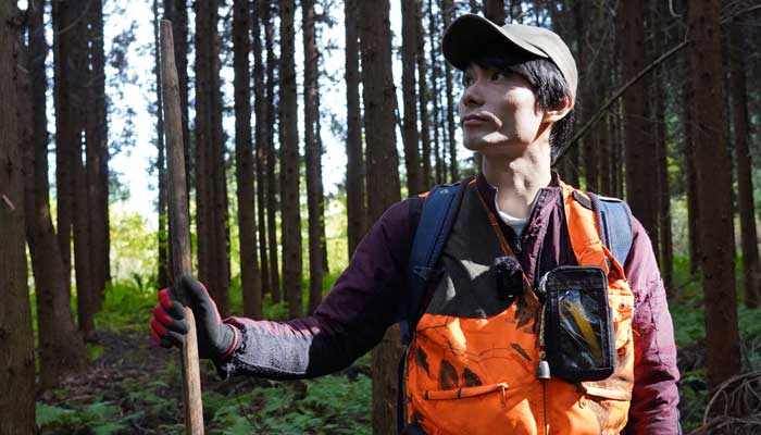 Hunter Kakeru Matsuhashi stands in a forest near Kita-Akita, Akita prefecture on October 25, 2025. — AFP