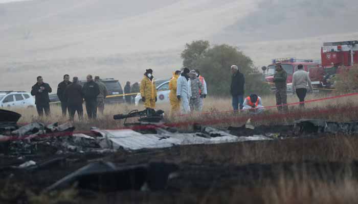 Members of emergency services work at the site of the Turkish C-130 military cargo plane crash near the Azerbaijani border, in Sighnaghi municipality, Georgia, November 12, 2025. — Reuters
