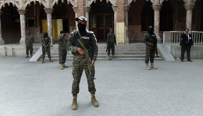 Security personnel stand guard in Lahore on February 25, 2017. — AFP
